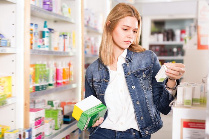 Woman shopping for AHCC supplements in the vitamin store